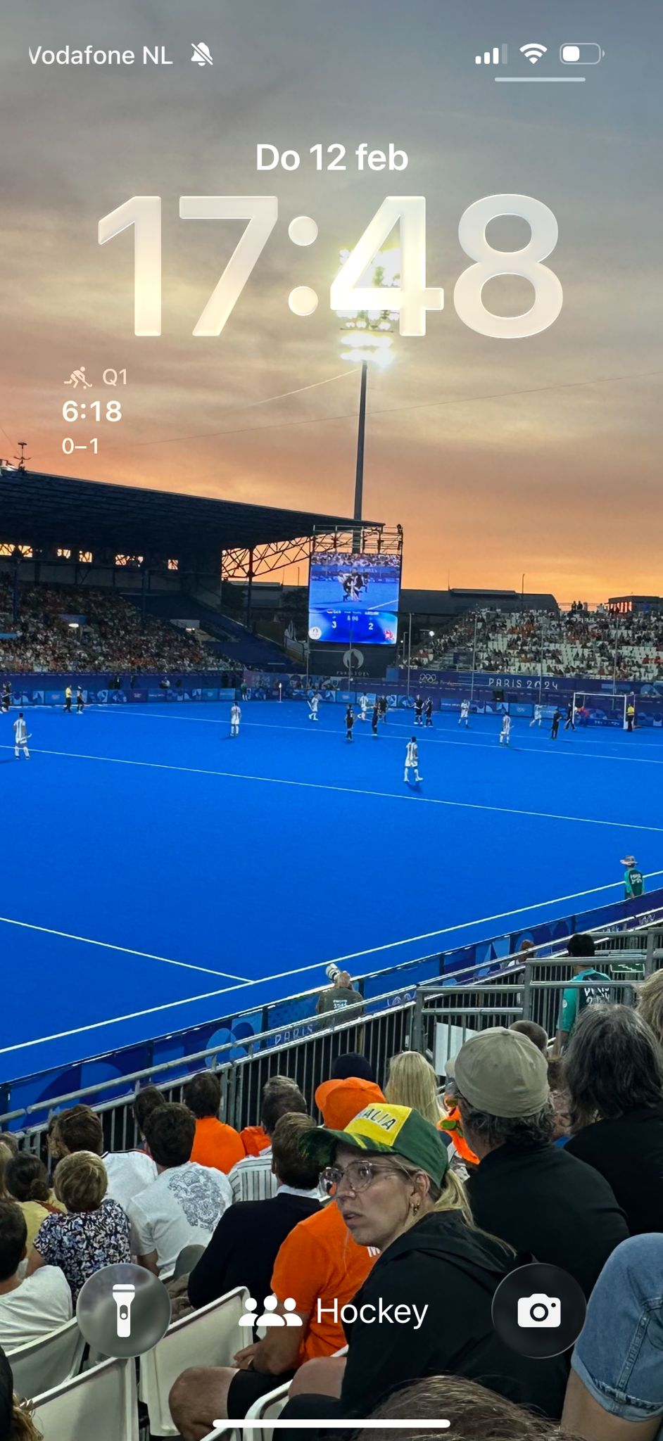 iPhone lock screen with HockeyUmpire widget active during a match